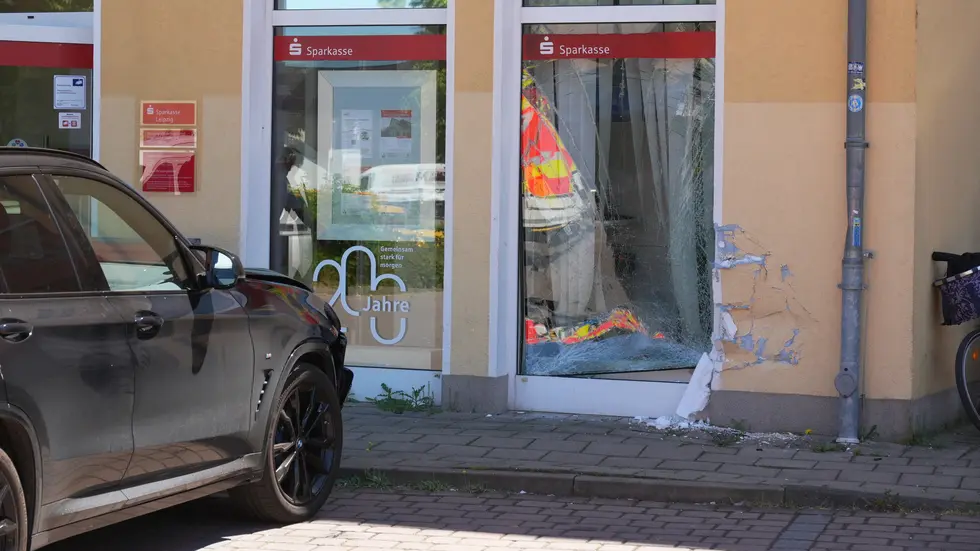 Der beschädigte BMW X3 vor der kaputten Außenscheibe der Bankfiliale. Der beschädigte BMW X3 vor der kaputten Außenscheibe der Bankfiliale.