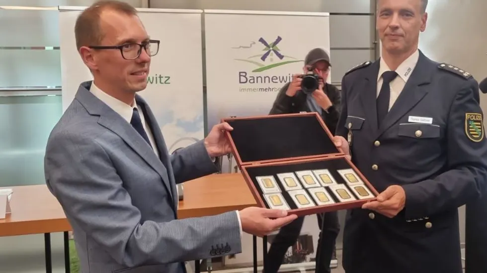 Bürgermeister von bannewitz Heiko Wersig und Polizeisprecher Thomas Geithner halten die 10 Goldunzen in den Händen