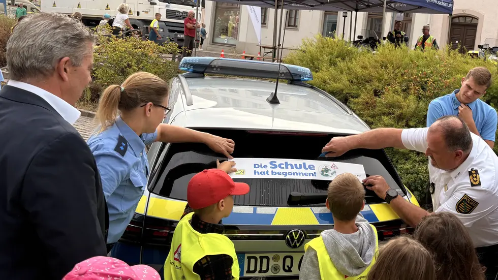 Polizeipräsident René Demmler klebt gemeinsam mit ABC Schützen "Achtung" Sticker auf Autos und Busse. Polizeipräsident René Demmler klebt gemeinsam mit ABC Schützen "Achtung" Sticker auf Autos und Busse.